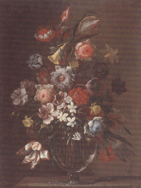 Still life of carnations,tulips,roses and daffodils,in a glass vase,upon a table-top